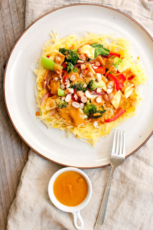 <p>Macheesmo</p><p>This roasted spaghetti squash is amped up with a veggie stir-fry topper, eggs, and a spicy homemade peanut sauce. Easy to make and perfect for fall!</p><p><a href="http://www.macheesmo.com/thai-spaghetti-squash-with-peanut-sauce/" rel="nofollow noopener" target="_blank" data-ylk="slk:Get the recipe here!;elm:context_link;itc:0;sec:content-canvas" class="link rapid-noclick-resp"><em><strong>Get the recipe here!</strong></em></a></p>