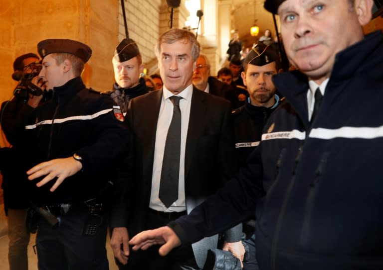 Gendarmes escort French former budget minister Jerome Cahuzac (C) as he leave the Paris courthouse following his tax fraud and money laundering trial's verdict on December 8, 2016