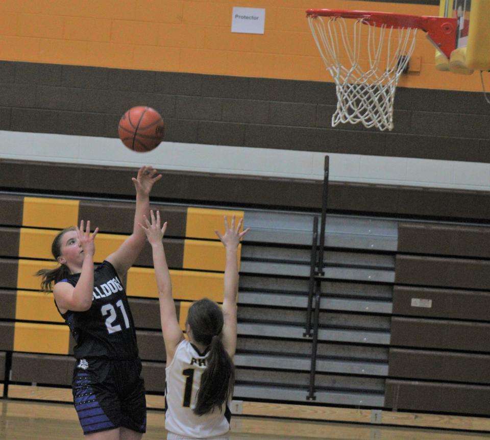 Inland Lakes junior forward Ashley Murray (21) puts up a shot during the fourth quarter at Pellston on Friday night.