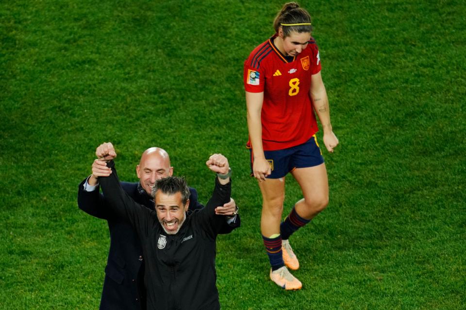 Jorge Vilda (left) celebrates Spain's World Cup semifinal win as forward Mariona Caldentey passes by.