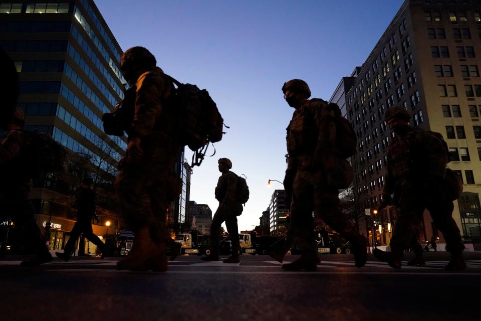 National Guards patrol the streets of the nation's capital on Tuesday night ahead of President-elect Joe Biden's inauguration ceremony.