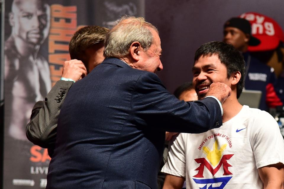 Boxing promoter Bob Arum gives Manny Pacquiao a playful jab on the cheek in May, on the eve of his &quot;Fight of the Century&quot; against Floyd Mayweather (AFP Photo/Frederic J. Brown)