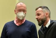 German sports doctor Mark S. (L), accused of masterminding an international doping network in cycling and winter sports, speaks with his lawyer Alexander Dann as he waits for the verdict in his trial at the Regional Court (Landgericht) in Munich