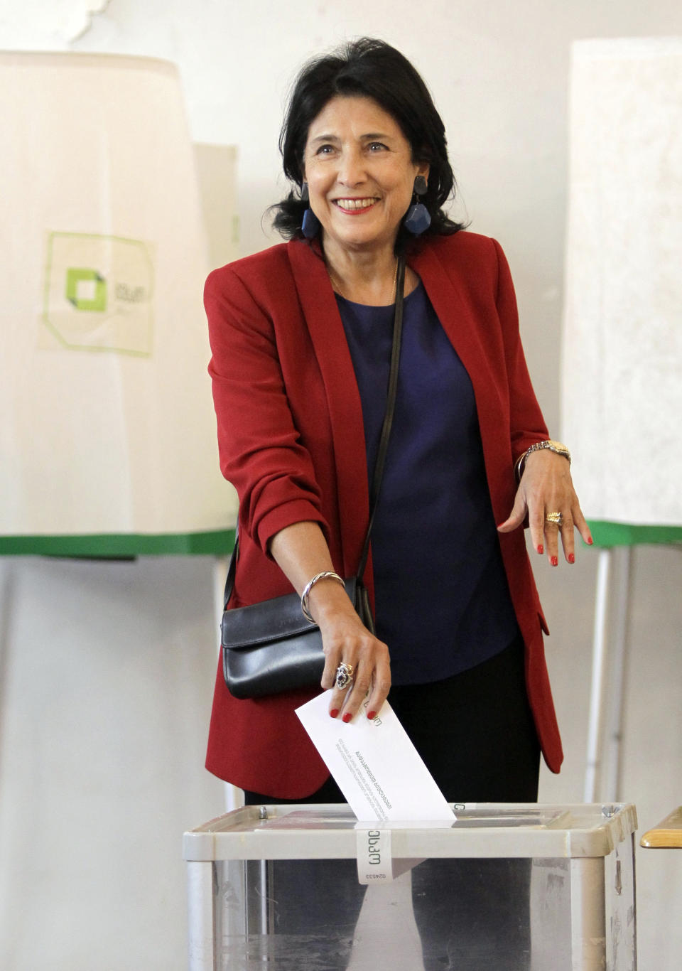 Salome Zurabishvili, former Georgian Foreign minister and presidential candidate from the European Georgia Party, casts her ballot at the polling station in Tbilisi, Georgia, Sunday, Oct. 28, 2018. Voters in Georgia are choosing a new president for the former Soviet republic, the last time the president will be elected by direct ballot. (AP Photo/Shakh Aivazov)