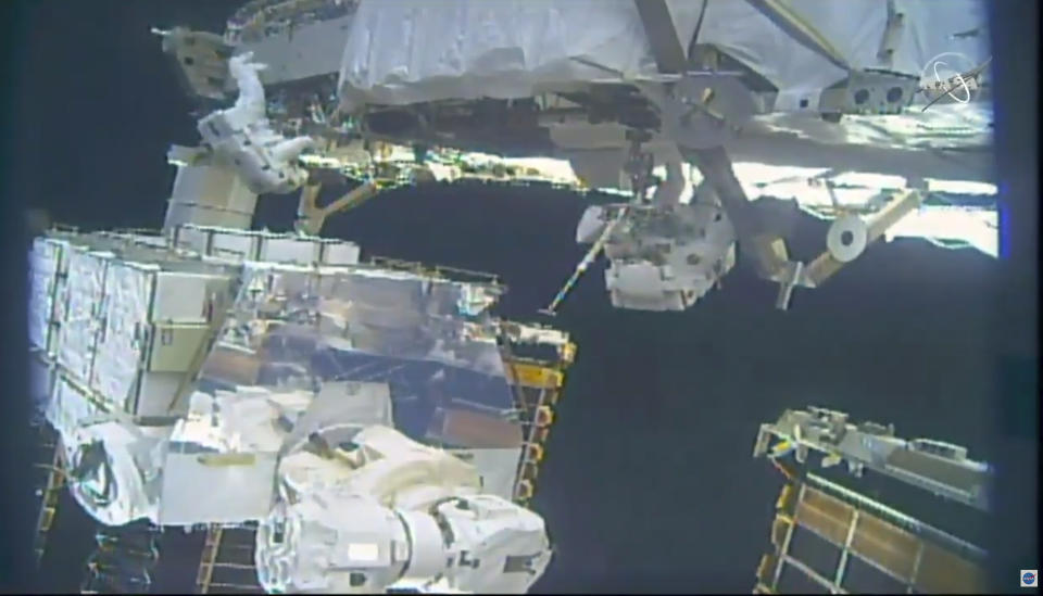 In this image take from NASA video, astronauts Jessica Meir, right, and Christina Koch install batteries for the International Space Station's solar power grid during a space walk Monday, Jan. 20, 2020. (NASA via AP)