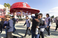 Orange Coast College baseball players arrive at a memorial service, Monday, Feb. 10, 2020, at Angel Stadium of Anaheim in Anaheim, Calif., honoring baseball coach John Altobelli, his wife, Keri, and their daughter Alyssa, who all died in a helicopter crash Jan. 26 in Calabasas, Calif. (AP Photo/Damian Dovarganes)