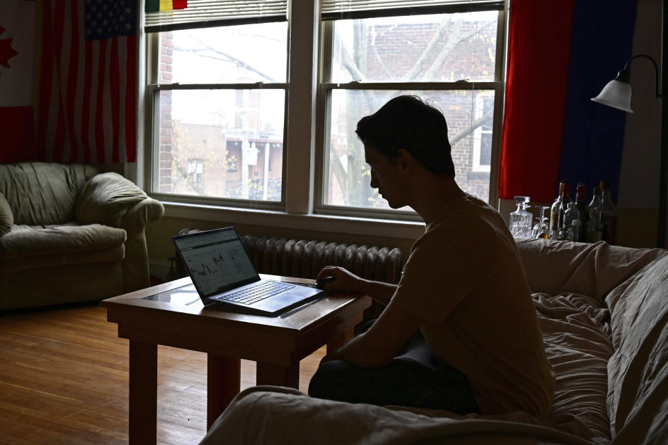 Amateur trader Manny Marotta looks at stock prices on his laptop in his apartment in Rocky River, Ohio, Wednesday, April 24, 2024. The legal writer from suburban Cleveland had been up about $4,000 on “put” options for Trump Media & Technology stock, purchased over the past few weeks. (AP Photo/David Dermer)