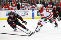 New Jersey Devils center Jack Hughes (86) shoots the puck against Ottawa Senators defenseman Thomas Chabot (72) during the second period of an NHL hockey game, Saturday, March 25, 2023, in Newark, N.J. (AP Photo/Noah K. Murray)