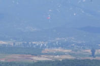 A North Korean flag flutters in the wind atop a 160-meter (525-foot) tower in the North's Kijong-dong village near the truce village of Panmunjom, seen from Paju, South Korea, Tuesday, May 28, 2024. A rocket launched by North Korea to deploy the country's second spy satellite exploded shortly after liftoff Monday, state media reported, in a setback for leader Kim Jong Un's hopes to operate multiple satellites to better monitor the U.S. and South Korea. (AP Photo/Lee Jin-man)