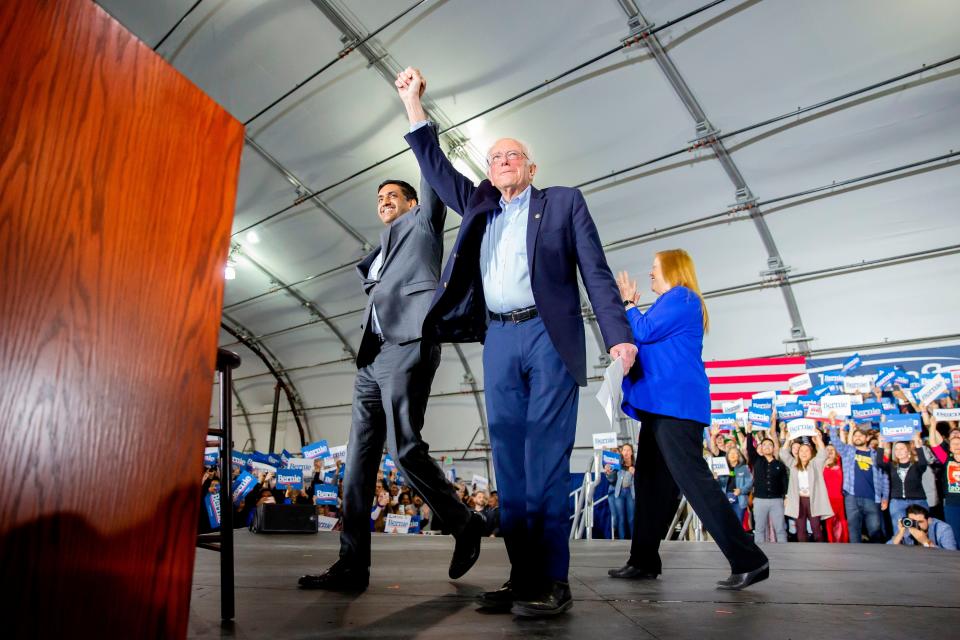 U.S. Representative (D-CA) Ro Khanna (L) arrives on stage with Democratic White House hopeful Vermont Senator Bernie Sanders (C) and his wife Jane Sanders for a Presidential election rally in San Jose, California on March 1, 2020.