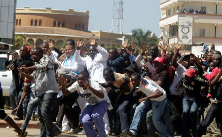 Democratic Republic of Congo's opposition Presidential candidate Moise Katumbi and his supporters react as riot police fire teargas at them as they walk to the prosecutor's office over government allegations he hired mercenaries in a plot against the state, in Lubumbashi, the capital of Katanga province of the Democratic Republic of Congo, May 13, 2016. REUTERS/Kenny Katombe