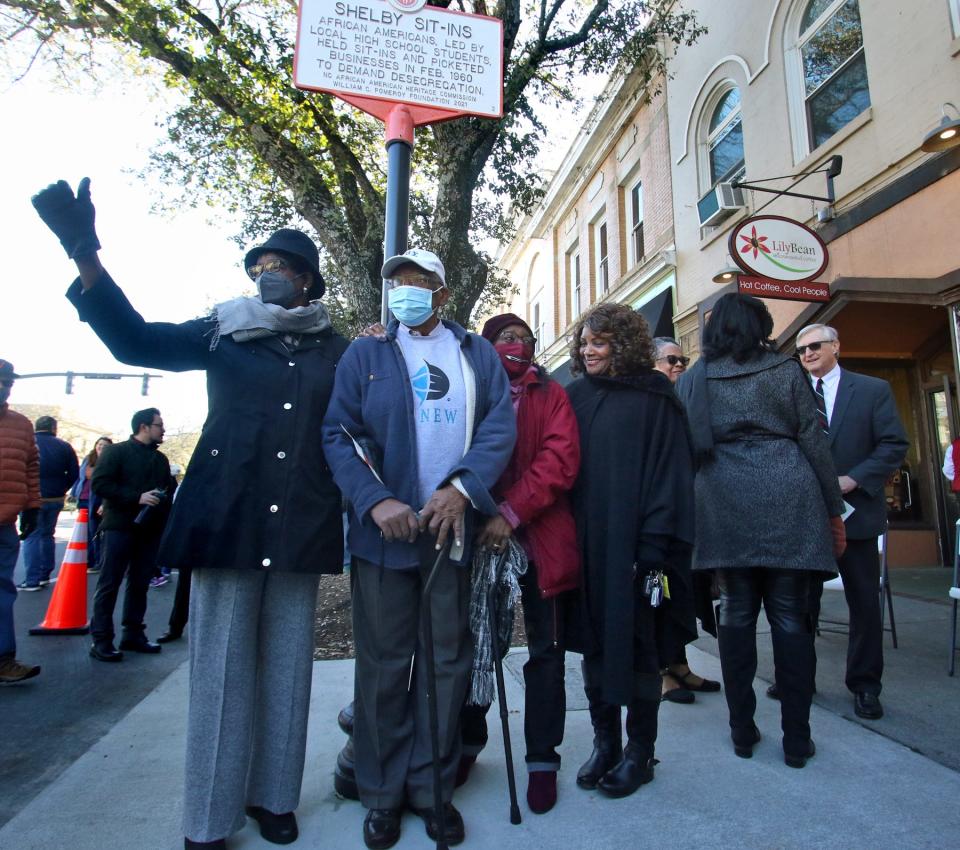 Lucretia Bell, Haywood Homsley, Charlotte Dixon and Carolyn Maddox pose for photos under the new marker during the NC Civil Rights Trail Marker Ceremony Saturday morning, Feb. 19, 2022, in front of the former Smith’s Drug Store in Shelby.