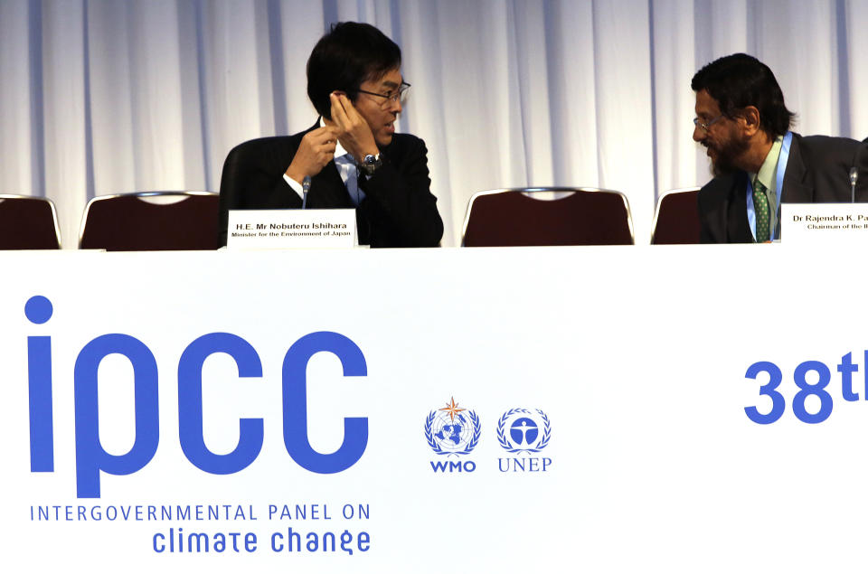 The chair of the Intergovernmental Panel on Climate Change (IPCC) Rajendra K. Pachauri, right, and Japan's Environment Minister Nobuteru Ishihara chat before an opening remarks during the opening session of the 10th Plenary of (IPCC) Working Group II and the 38th Session of the IPCC in Yokohama, near Tokyo Tuesday, March 25, 2014. The hundreds of scientists from 100 countries meeting in this Japanese port city are putting finishing touches on a massive report emphasizing the gravity of the threat the changing climate poses for communities from the polar regions to the tropics. (AP Photo/Eugene Hoshiko)