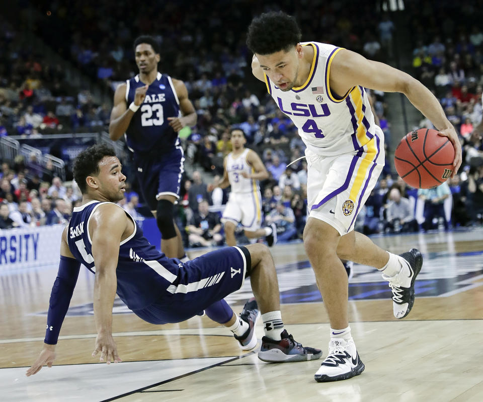 Yale 's Azar Swain, left, falls backward as LSU's Skylar Mays (4) drives past him to the basket during the first half of a first round men's college basketball game in the NCAA Tournament in Jacksonville, Fla., Thursday, March 21, 2019. (AP Photo/John Raoux)