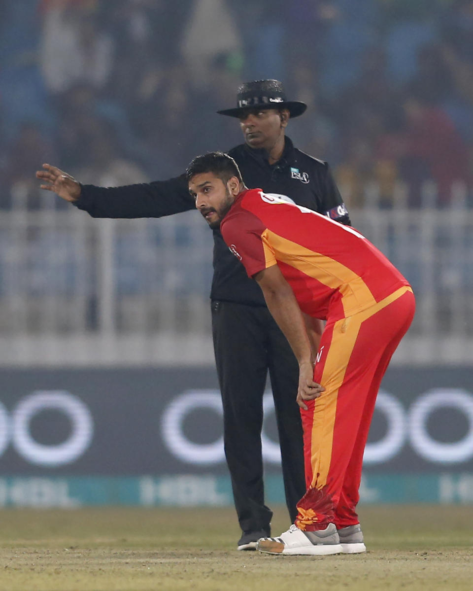 Islamabad United pacer Rumman Raees, front, reacts while umpire Ranmore Martinesz gives no-ball signal shot during the Pakistan Super League T20 cricket match against Quetta Gladiators at Rawalpindi Stadium, in Rawalpindi, Pakistan, Thursday, Feb. 27, 2020. (AP Photo/Anjum Naveed)