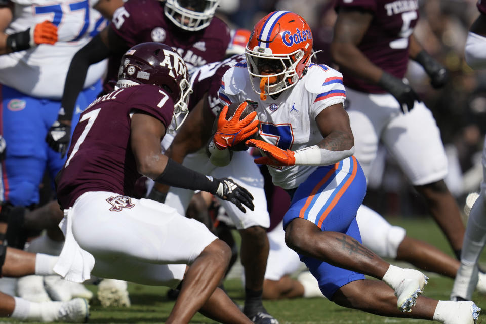 Florida running back Trevor Etienne (7) gets past Texas A&M defensive back Tyreek Chappell (7) during a run in the first quarter of an NCAA college football game Saturday, Nov. 5, 2022, in College Station, Texas. (AP Photo/Sam Craft)