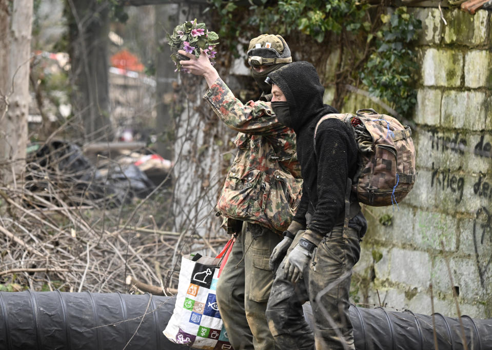 Five days after the eviction of Luetzerath began, two remaining climate activists leave an underground tunnel under a building in Luetzerath, Germany, Monday, Jan. 16, 2023. (Roberto Pfeil/dpa via AP)