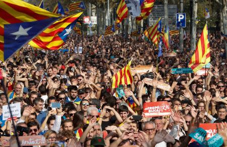 People react as they watch on giant screens a plenary session outside the Catalan regional parliament in Barcelona, Spain, October 27, 2017. REUTERS/Yves Herman