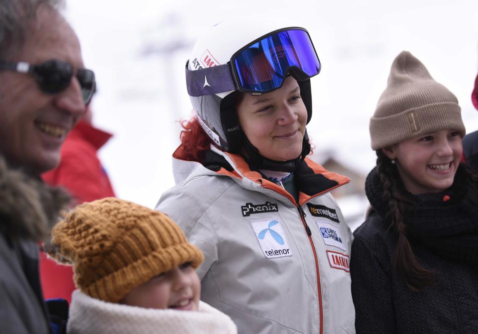 Local fans gather around for a picture with Kiana Kryeziu, center, at the Arxhena Ski center in Dragas, Kosovo on Saturday, Jan. 22, 2022. The 17-year-old Kryeziu is the first female athlete from Kosovo at the Olympic Winter Games after she met the required standards, with the last races held in Italy. (AP Photo/Visar Kryeziu)