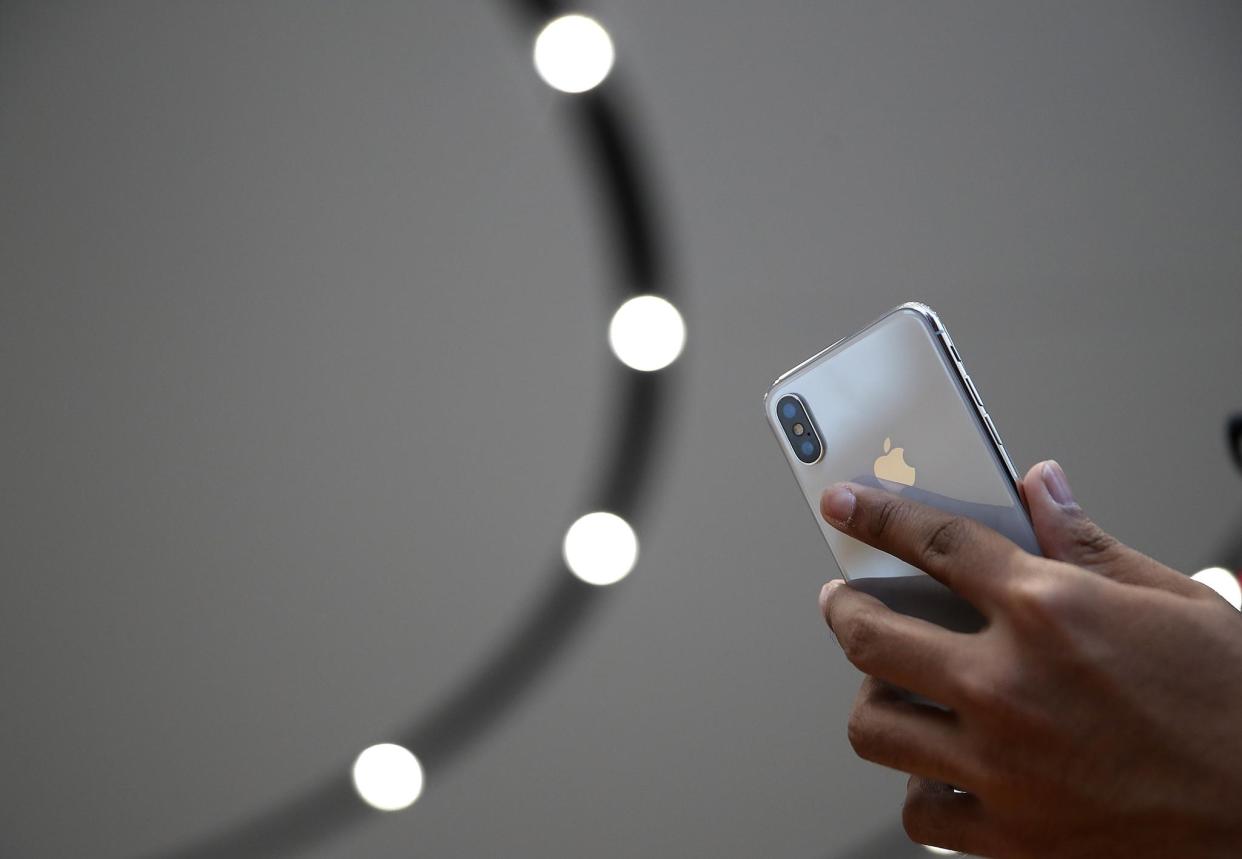 An attendee looks at a new iPhone X during an Apple special event at the Steve Jobs Theatre on the Apple Park campus on September 12, 2017 in Cupertino, California: Justin Sullivan/Getty Images