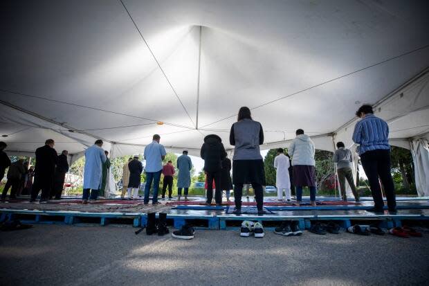 Muslims pray during Eid al-Fitr marking the end of Ramadan in the parking lot of Richmond Jamea Masjid in Richmond, B.C., on Thursday.  (Ben Nelms/CBC - image credit)