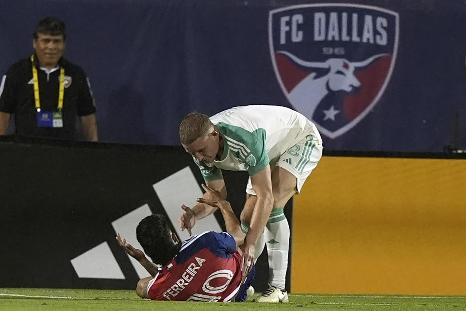Austin FC midfielder Alexander Ring, right, offers to help up Dallas forward Jesus Ferreira (10) after Ferreira scored during the second half of an MLS soccer match Saturday, May 11, 2024, in Frisco, Texas. (AP Photo/LM Otero)