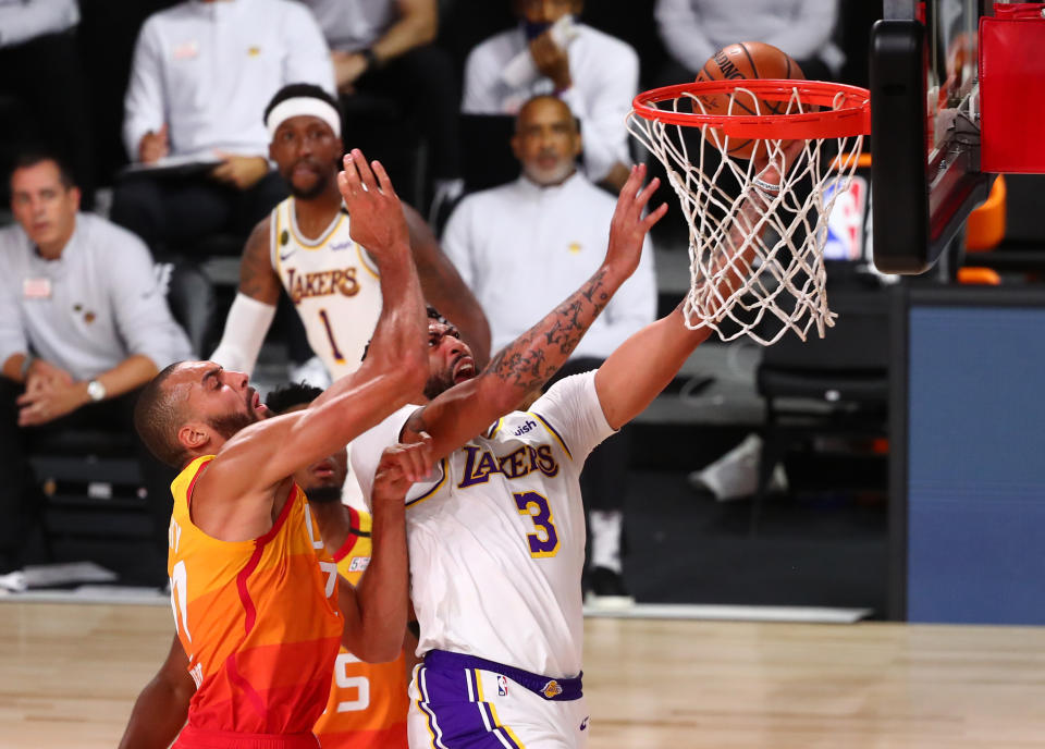 Anthony Davis goes to the hoop around Rudy Gobert.