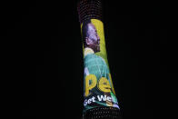 An image of former Brazilian player Pele with the message "Pele, Get well soon" is displayed on the Torch tower outside the Khalifa International Stadium in Doha, Qatar, Saturday, Dec. 3, 2022. Pele was hospitalized in Sao Paulo to regulate the medication in his fight against a colon tumor, his daughter said on Wednesday, Nov. 30, 2022. (AP Photo/Luca Bruno)