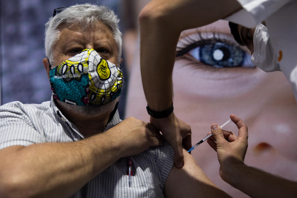 A man receives the second Pfizer-BioNTech COVID-19 vaccine at a vaccination center in Jerusalem, during a nationwide lockdown to curb the spread of the virus, Monday, Jan. 11, 2021. (AP Photo/Oded Balilty)