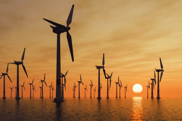 Offshore wind turbine farm at sunset. (Photo: imaginima via Getty Images)