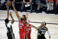 Sacramento Kings' De'Aaron Fox (5) shoots against New Orleans Pelicans' Derrick Favors (22) during the second half of an NBA basketball game Thursday, Aug. 6, 2020 in Lake Buena Vista, Fla. (AP Photo/Ashley Landis, Pool)