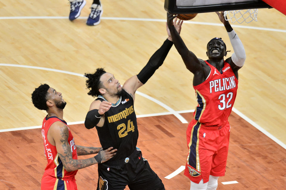 New Orleans Pelicans forward Wenyen Gabriel, right, and Memphis Grizzlies forward Dillon Brooks, center, reach for the ball as guard Nickeil Alexander-Walker, left, moves for position in the first half of an NBA basketball game Monday, May 10, 2021, in Memphis, Tenn. (AP Photo/Brandon Dill)