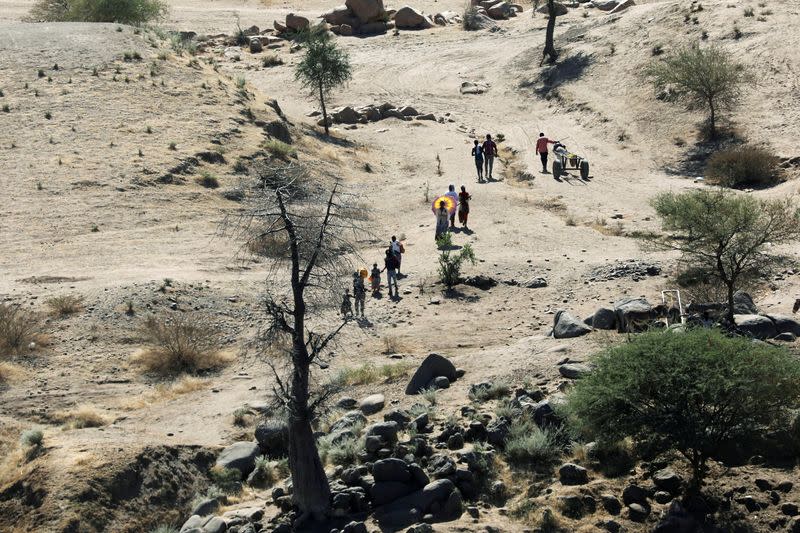 FILE PHOTO: Ethiopians fleeing from the Tigray region walk towards river to cross from Ethiopia to Sudan