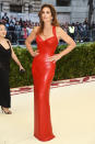 <p>Looking every inch the legendary supermodel, Cindy Crawford commanded the red carpet in this red, skin-tight Versace column dress. Photo: Getty Images </p>