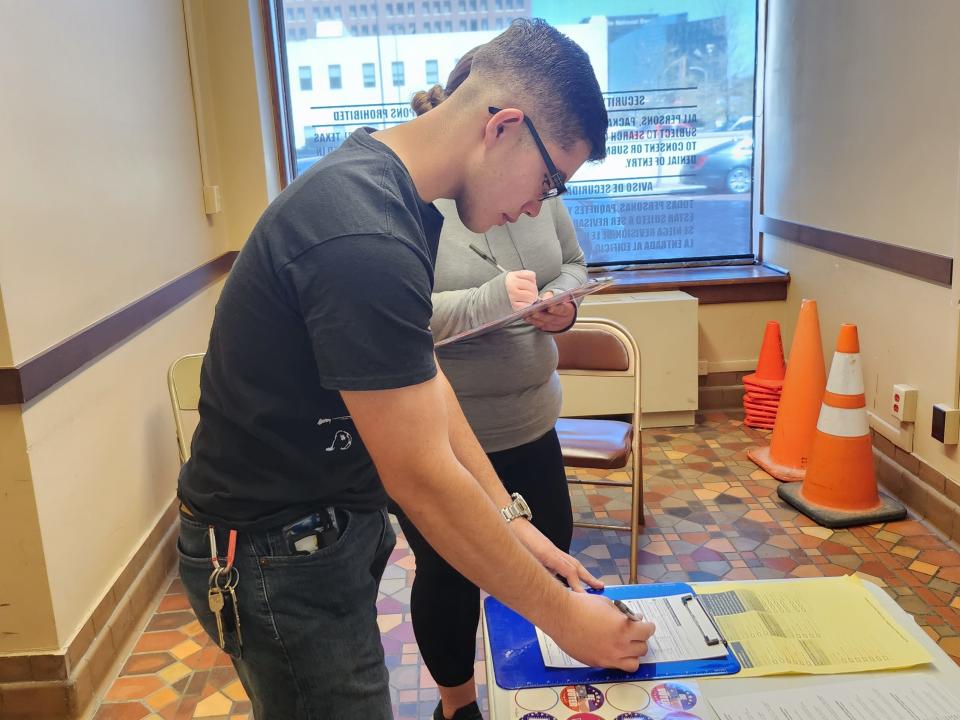 Andrew Guerra registers to vote, with the help of the Amarillo League of Women Voters before registration closes Thursday afternoon for the May elections, at the Potter County Elections Office.