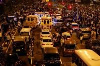 Anti-government demonstrators block a road near the Hong Kong Polytechnic University (PolyU) in Hong Kong