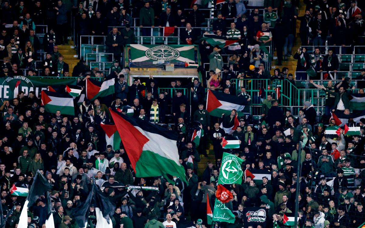 Score and updates as home fans wave Palestine flags