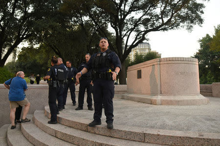 Police officers move people back from the area where Confederate general Robert E. Lee was removed in Dallas, Texas, U.S., September 14, 2017. REUTERS/Rex Curry