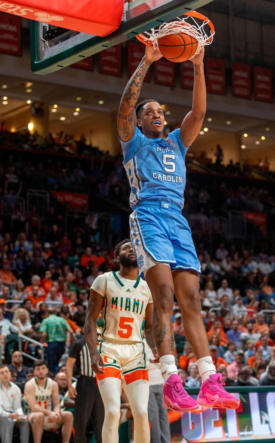 North Carolina’s Armando Bacot (5) gets a dunk over Miami’s Wooga Poplar (5) in the first half on Saturday, February 10, 2024 at the Watsco Center in Coral Gables, Florida. Robert Willett/rwillett@newsobserver.com
