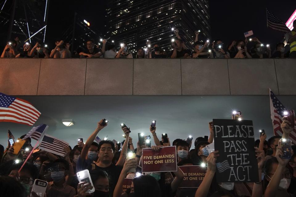 Protestors light their torches during a peaceful rally in central Hong Kong's business district, Monday, Oct. 14, 2019. The protests that started in June over a now-shelved extradition bill have since snowballed into an anti-China campaign amid anger over what many view as Beijing's interference in Hong Kong's autonomy that was granted when the former British colony returned to Chinese rule in 1997. (AP Photo/Felipe Dana)