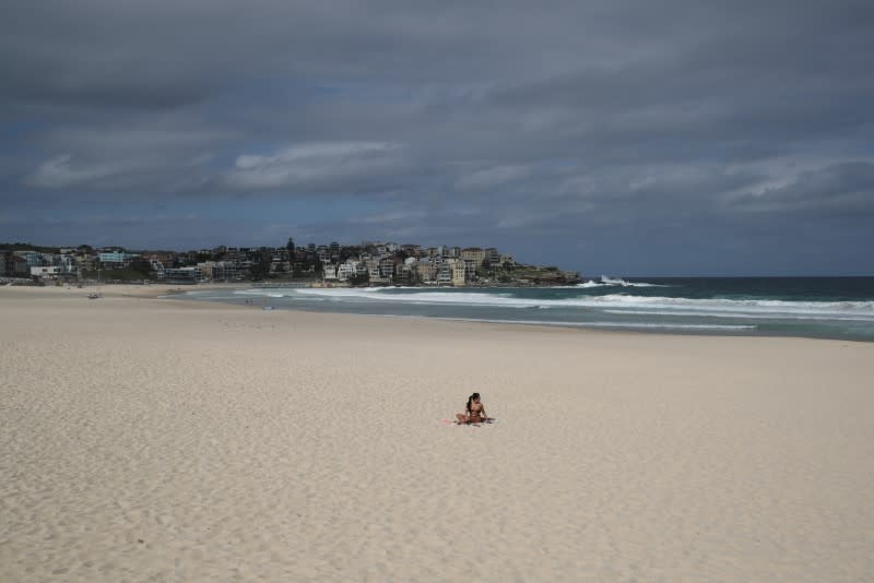 A single sunbather remains following the closure of Bondi Beach to prevent the spread of the coronavirus disease (COVID-19) in Sydney