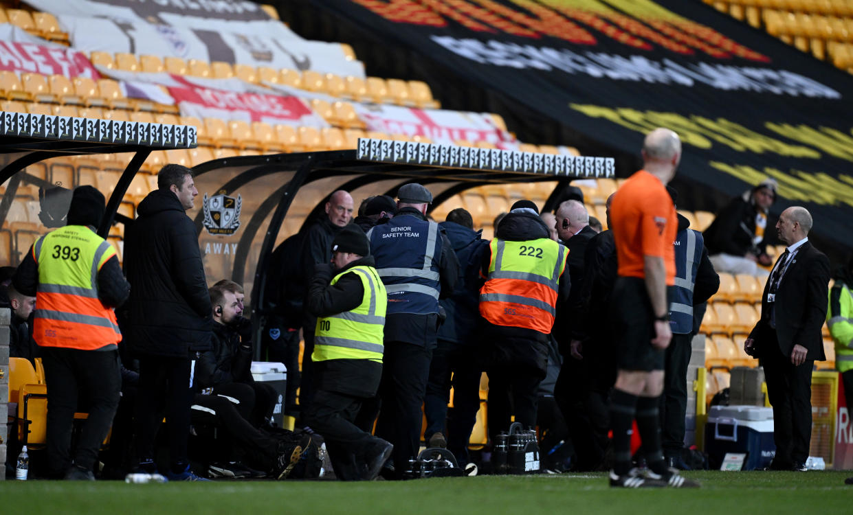 BURSLEM, ENGLAND - JANUARY 27: Ground stewards remove a fan who invaded the field to confront referee Craig Hicks during the Sky Bet League One match between Port Vale and Portsmouth at Vale Park on January 27, 2024 in Burslem, England. (Photo by Gareth Copley/Getty Images)