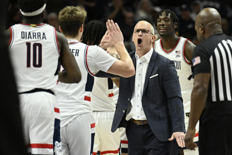 UConn head coach Dan Hurley greets player Cam Spencer during a time out in the first half of an NCAA college basketball game against DePaul, Tuesday, Jan. 2, 2024, in Storrs, Conn. (AP Photo/Jessica Hill)