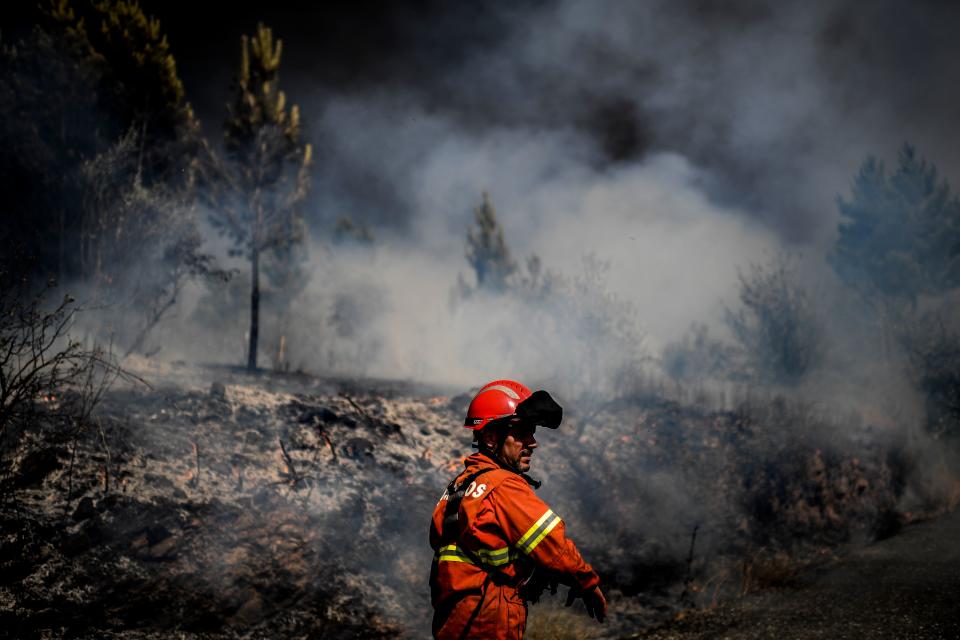 A firefighter is at work to extinguish a wildfire at Roda village in Macao, central Portugal on July 21, 2019. (Photo: Patricia De Melo Moreira/AFP/Getty Images)