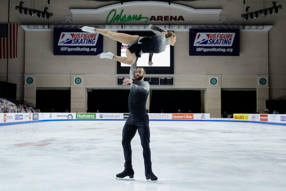 Timothy holding Ashley above his head with one leg