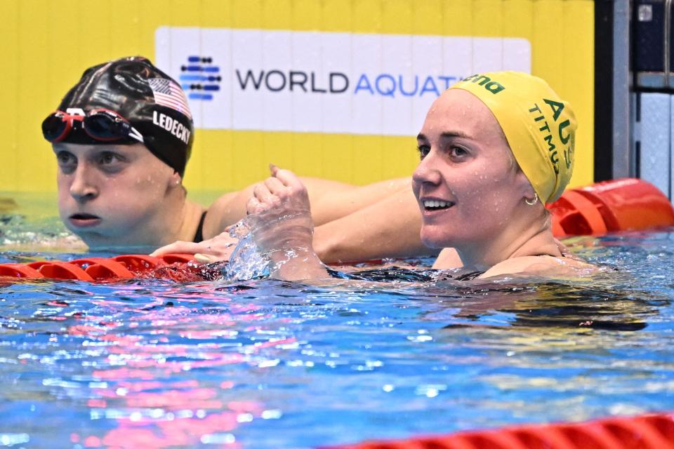 Australia's Ariarne Titmus (right) reacts after winning and breaking the world record next to USA's Katie Ledecky in the final of the women's 400m freestyle swimming event during the World Aquatics Championships in Fukuoka, Japan