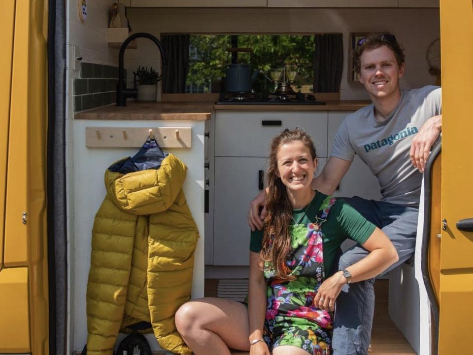 Low and Comley sitting at the doorway of their van.