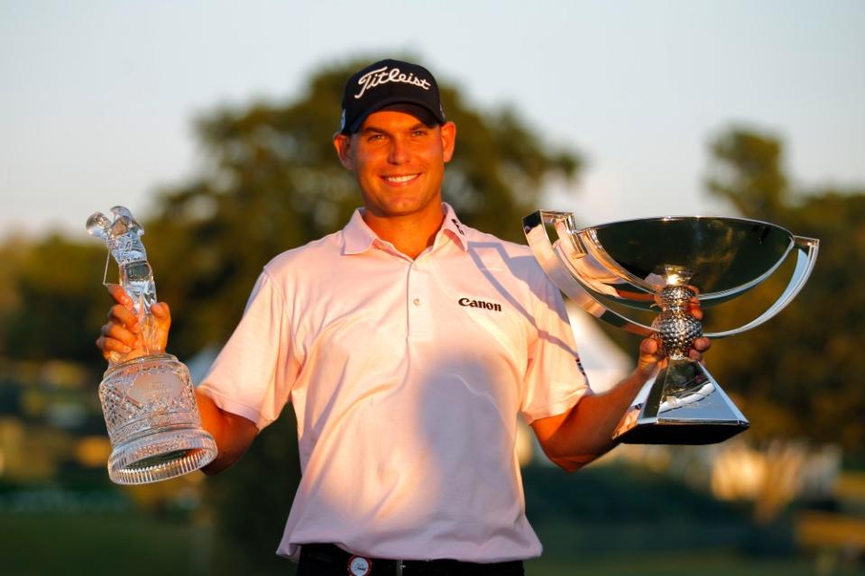 Bill Haas holds the trophies after winning in the final round of the FedEx Cup – The Tour Championship at East Lake Golf Club in Atlanta, Georgia. (Photo by Todd Kirkland/Icon SMI/Corbis/Icon Sportswire via Getty Images)