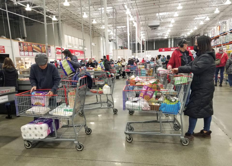 People line up to check out at a Costco store in Vancouver, British Columbia, Canada, on January 17, 2023.