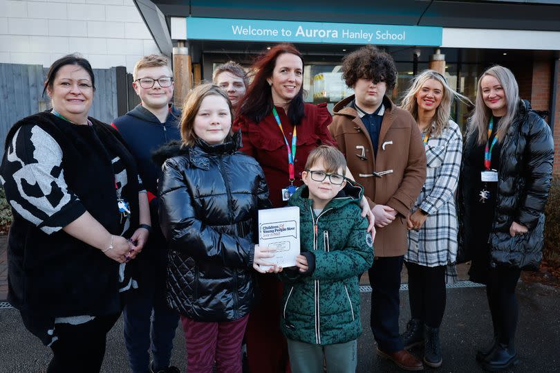 Head of School Julie Martin, centre, with students and staff at Aurora Hanley School in Bucknall. -Credit:Pete Stonier / Stoke Sentinel